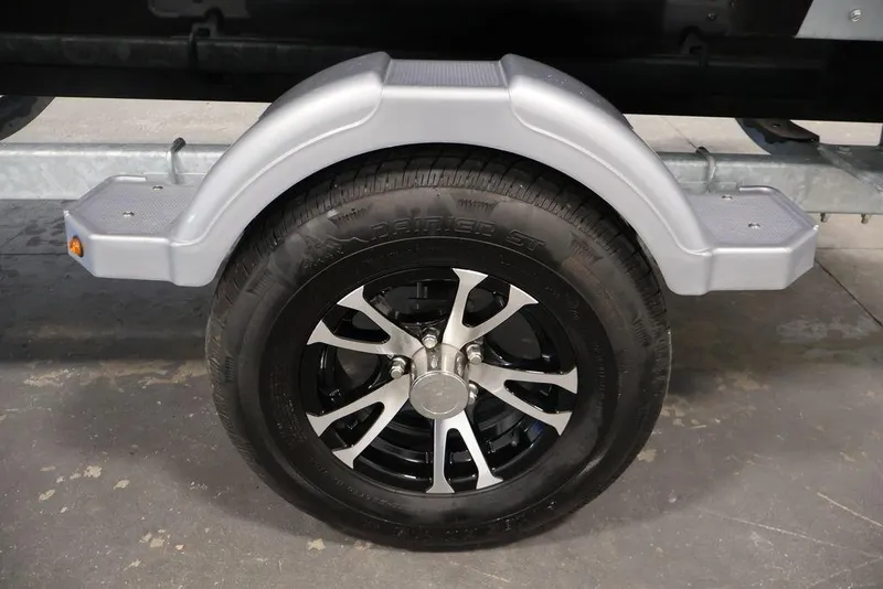 Slide: The Image of 2024 Crestliner XFC 179 trailer wheel with sleek black and silver alloy rim. - 18
