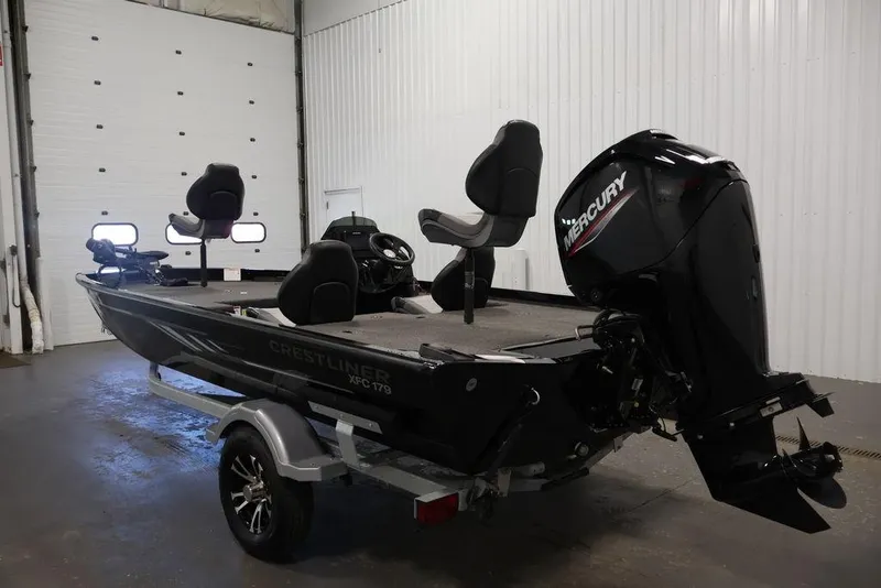 Slide: The Image of 2024 Crestliner XFC 179 fishing boat with Mercury outboard motor in a garage setting. - 19