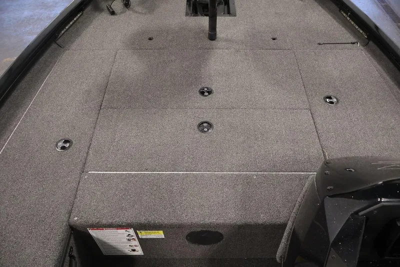 Slide: The Image of 2024 Crestliner XFC 179 boat interior with carpeted deck and storage compartments. - 25