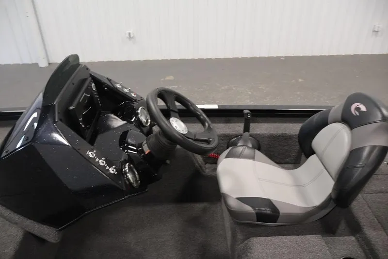 Slide: The Image of 2024 Crestliner XFC 179 boat cockpit with steering wheel and cushioned seat. - 26