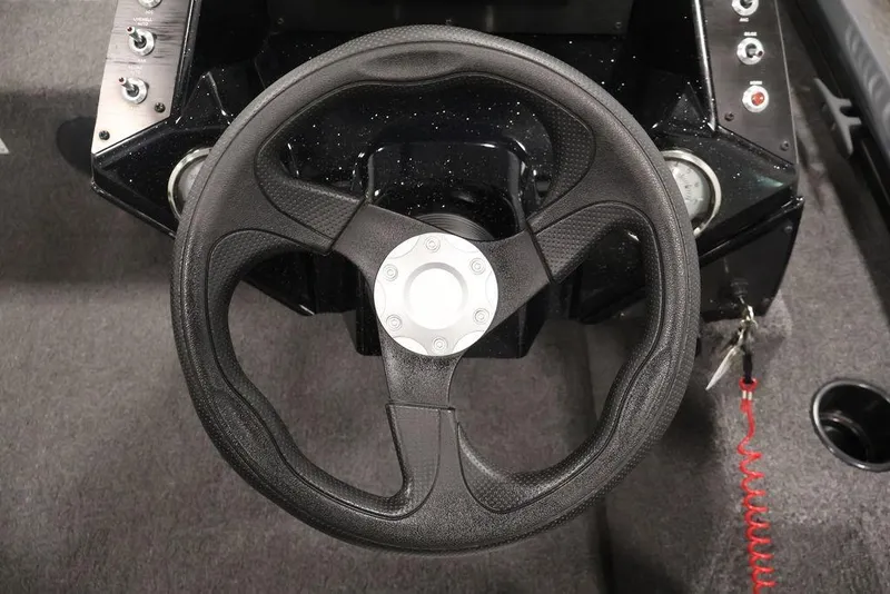 Slide: The Image of Steering wheel of 2024 Crestliner XFC 179 boat, featuring control panel and gauges. - 31