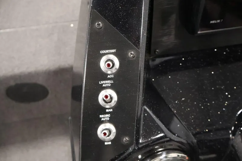Slide: The Image of 2024 Crestliner XFC 179 boat control panel with courtesy and livewell switches. - 34