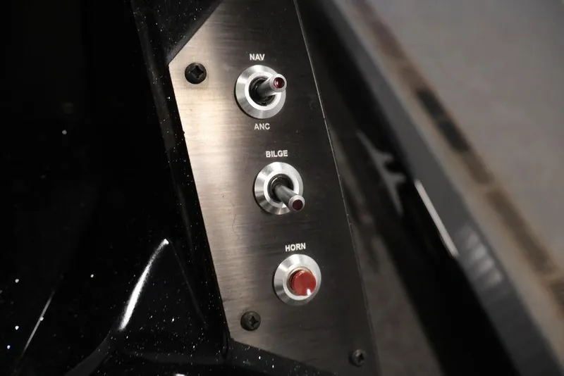 Slide: The Image of Control panel of 2024 Crestliner XFC 179 boat with switches for navigation, bilge, and horn. - 35