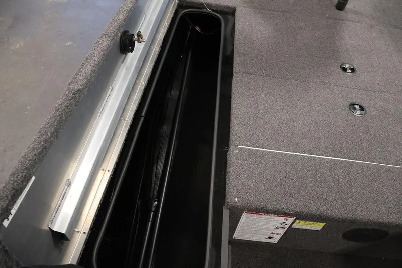 Slide: The Image of 2024 Crestliner XFC 179 boat interior storage compartment with carpeted finish. - 47