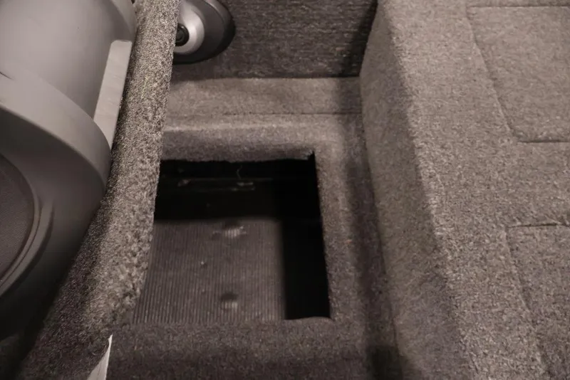 Slide: The Image of 2024 Crestliner XFC 179 boat interior storage compartment with carpeted finish. - 48
