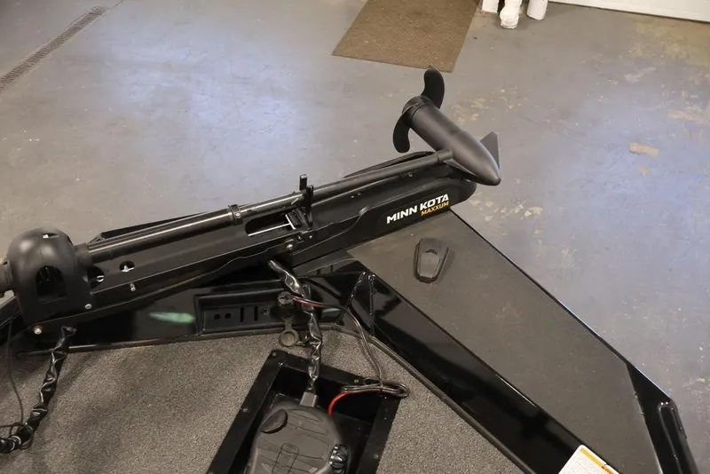 Slide: The Image of 2024 Crestliner XFC 179 boat with Minn Kota Maxxum trolling motor in a garage setting. - 49