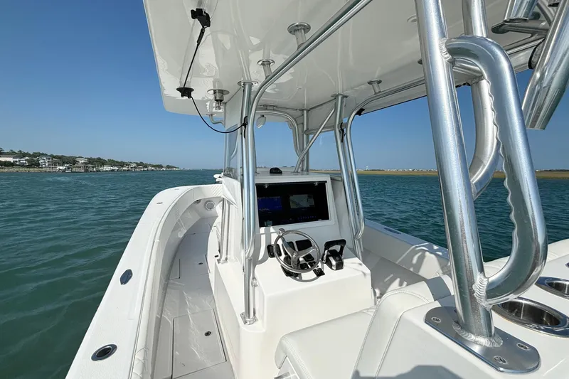 Slide: The Image of 2025 Competition 31 boat interior with steering console on open water. - 10