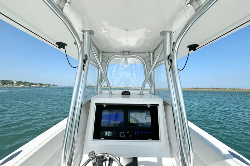 Slide: The Image of 2025 Competition 31 boat cockpit with navigation screens, cruising on open water. - 11
