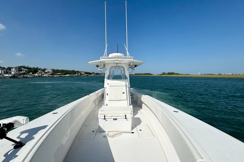 Slide: The Image of 2025 Competition 31 boat cruising on clear blue water under a sunny sky. - 13