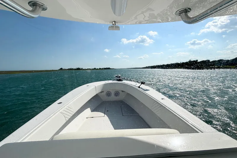 Slide: The Image of 2025 Competition 31 boat cruising on a sunny day with clear blue skies and calm waters. - 17