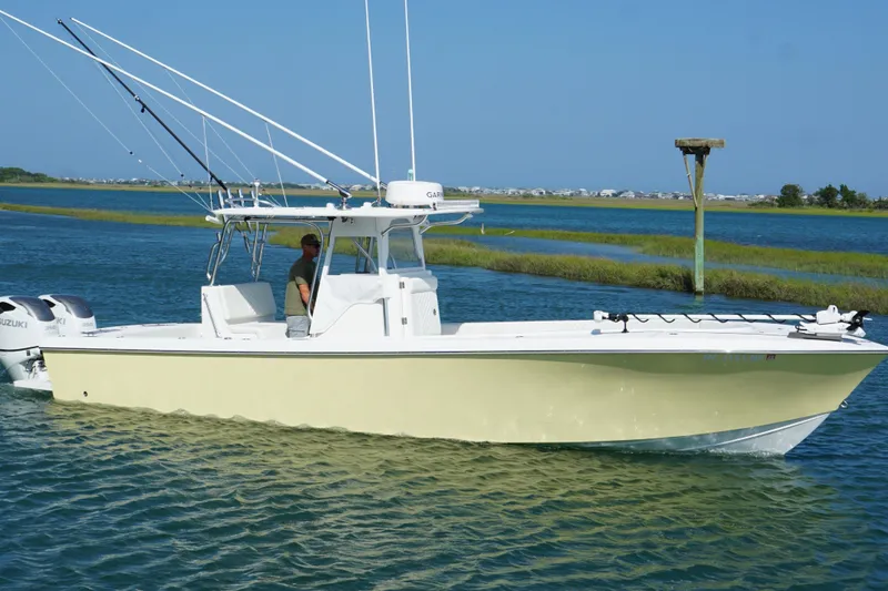 Slide: The Image of 2025 Competition 31 boat cruising on a sunny day with fishing rods and dual engines. - 2