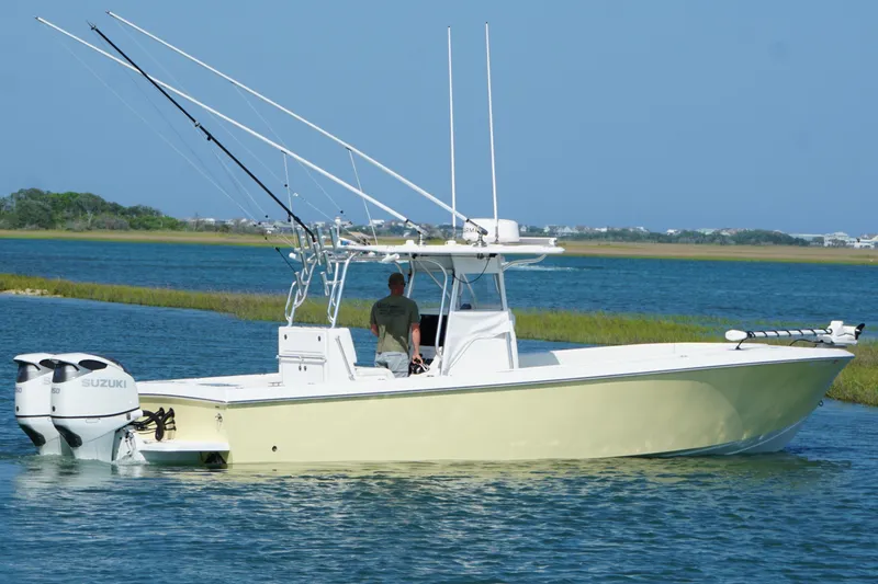 Slide: The Image of 2025 Competition 31 boat with dual Suzuki engines on a serene waterway. - 5