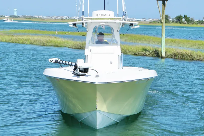 Slide: The Image of 2025 Competition 31 boat navigating through calm waters with lush green shoreline. - 7