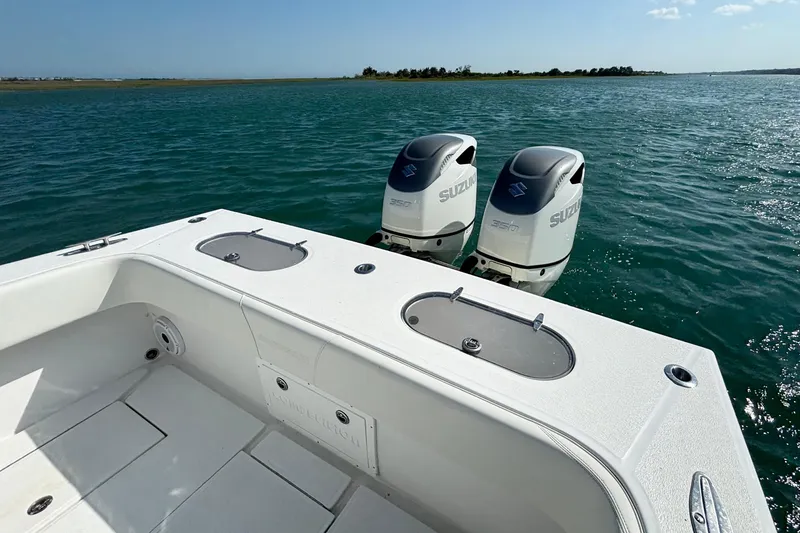 Slide: The Image of 2025 Competition 31 boat with twin Suzuki outboard motors on a calm sea. - 9