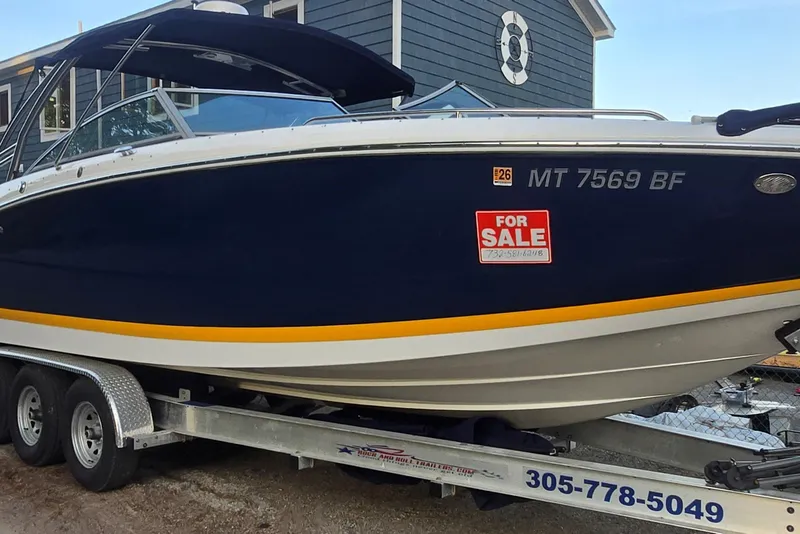 The Image of 2013 Cobalt 296 boat for sale on trailer, navy blue with yellow stripe. - 0