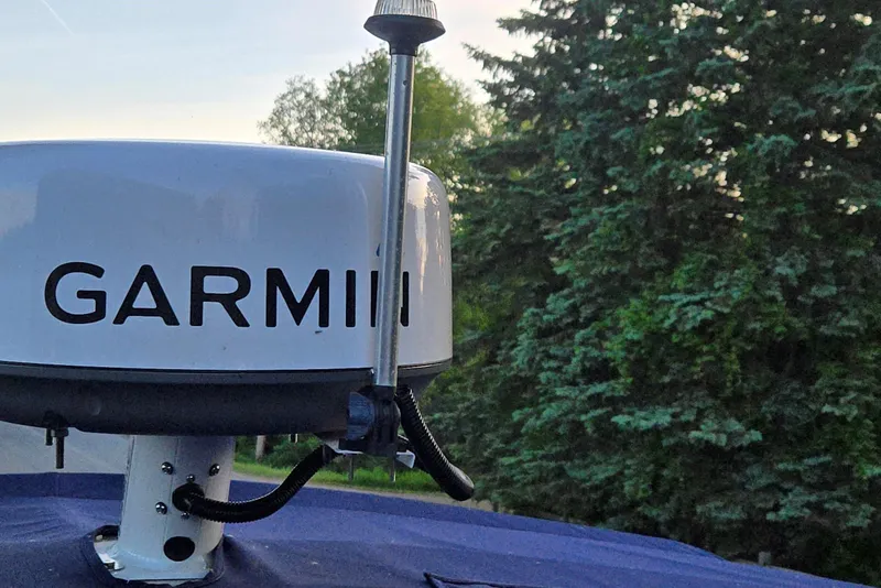 Slide: The Image of Garmin radar on a 2013 Cobalt 296 boat, surrounded by trees. - 11