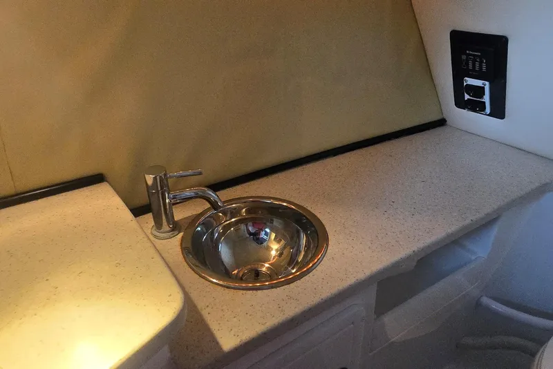 Slide: The Image of 2013 Cobalt 296 boat interior with a compact sink and countertop. - 16