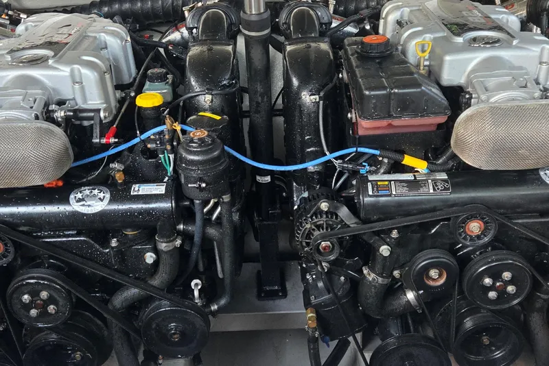 Slide: The Image of Twin engines of a 2013 Cobalt 296 boat, showcasing intricate mechanical details. - 17