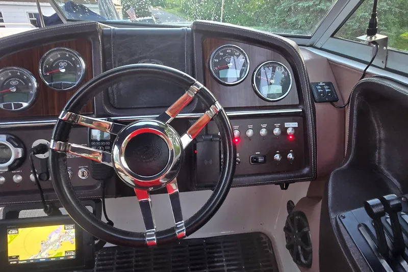 Slide: The Image of Dashboard of a 2013 Cobalt 296 boat with steering wheel and gauges. - 3