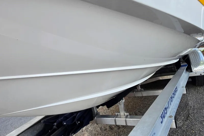 Slide: The Image of 2013 Cobalt 296 boat hull on trailer, showcasing sleek design and craftsmanship. - 6