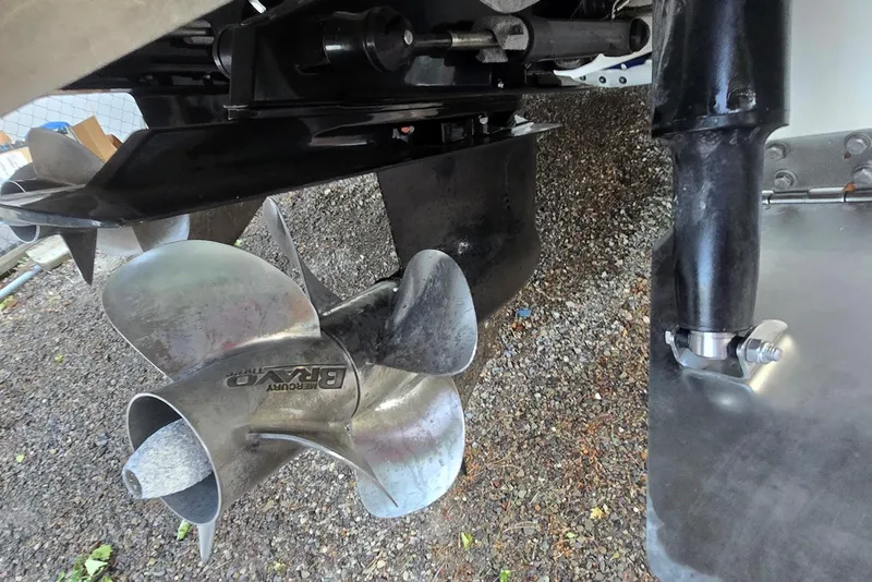 Slide: The Image of Close-up of 2013 Cobalt 296 boat propeller and outdrive on gravel surface. - 8