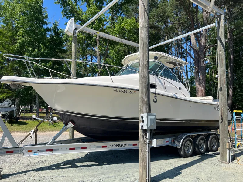The Image of 2008 Pursuit OS 285 Offshore on a trailer outdoors. - 0