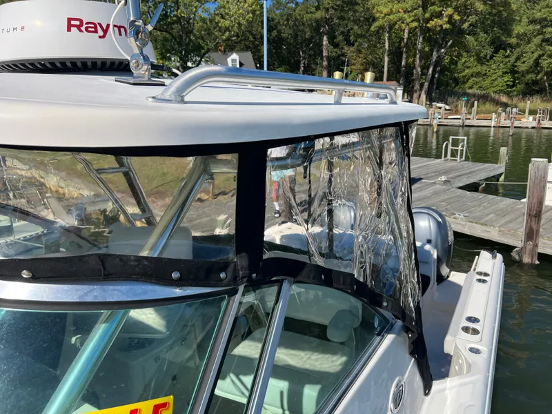 Slide: The Image of A 2008 Pursuit OS 285 Offshore with clear plastic windows and a sturdy roof. - 34