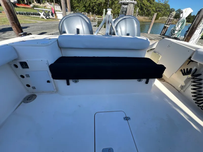 Slide: The Image of The image shows the cockpit of a 2008 Pursuit OS 285 Offshore with white and black seating. - 44