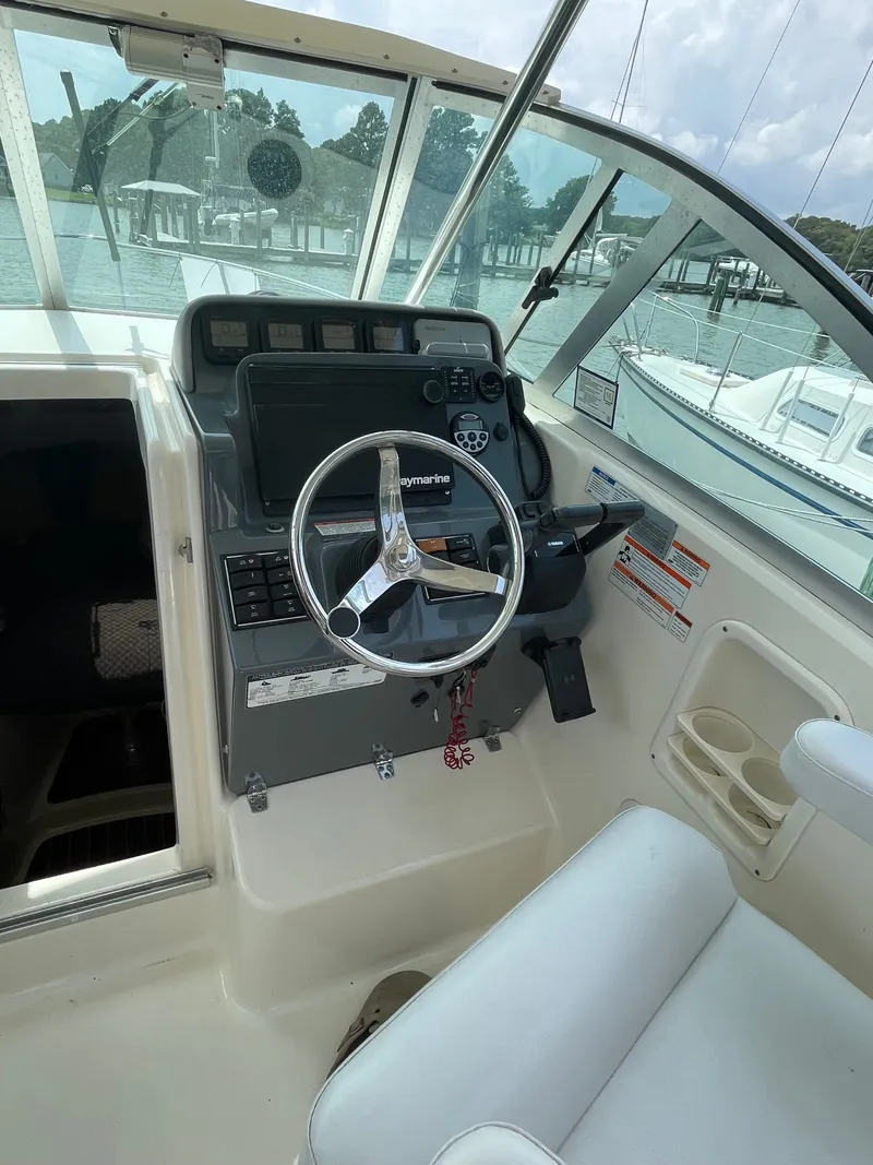 Slide: The Image of The cockpit of the 2008 Pursuit OS 285 Offshore features a modern helm with instruments. - 5