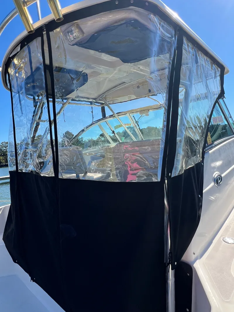 Slide: The Image of The 2008 Pursuit OS 285 Offshore features a clear canopy and spacious cabin. - 38