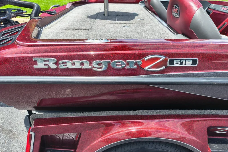 Slide: The Image of 2022 Ranger Z518 boat with red metallic finish and logo detailing. - 10