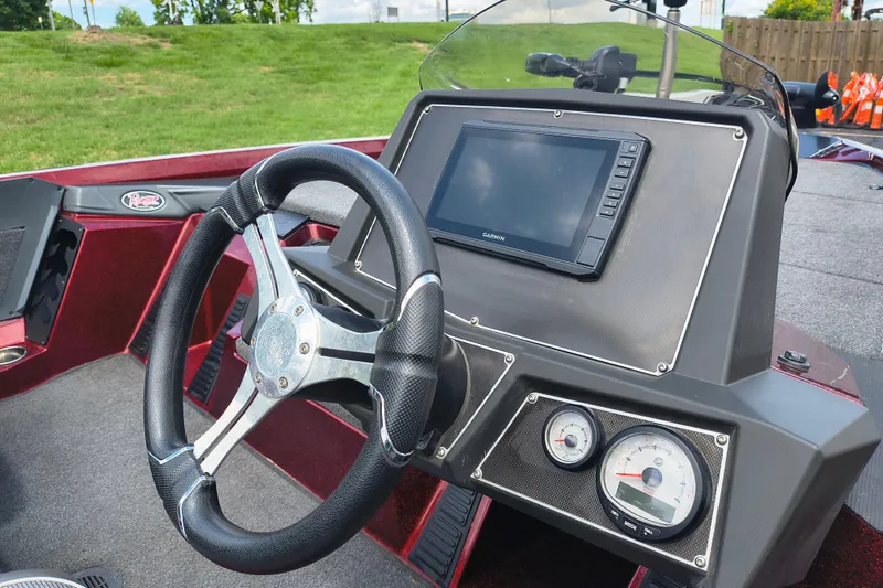 Slide: The Image of 2022 Ranger Z518 boat dashboard with steering wheel and Garmin display. - 11