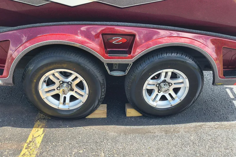 Slide: The Image of 2022 Ranger Z518 trailer with dual wheels on a parking lot, featuring shiny rims. - 7
