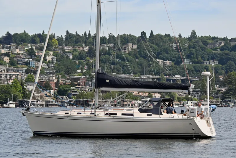 The Image of 2004 Hanse 411 sailboat on a scenic lake with lush green hills in the background. - 0