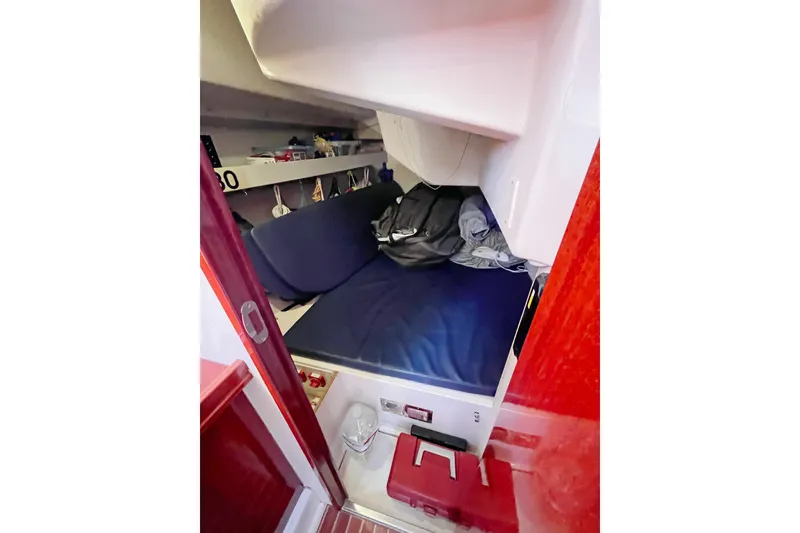 Slide: The Image of Cozy cabin interior of 2004 Hanse 411 sailboat with blue bedding and storage shelves. - 12