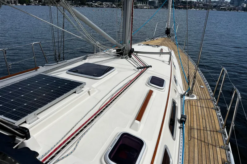 Slide: The Image of 2004 Hanse 411 sailboat deck with solar panel, moored on calm water. - 16