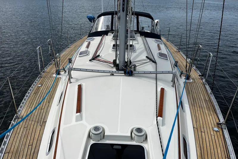 Slide: The Image of 2004 Hanse 411 sailboat deck with wooden accents on calm water. - 20