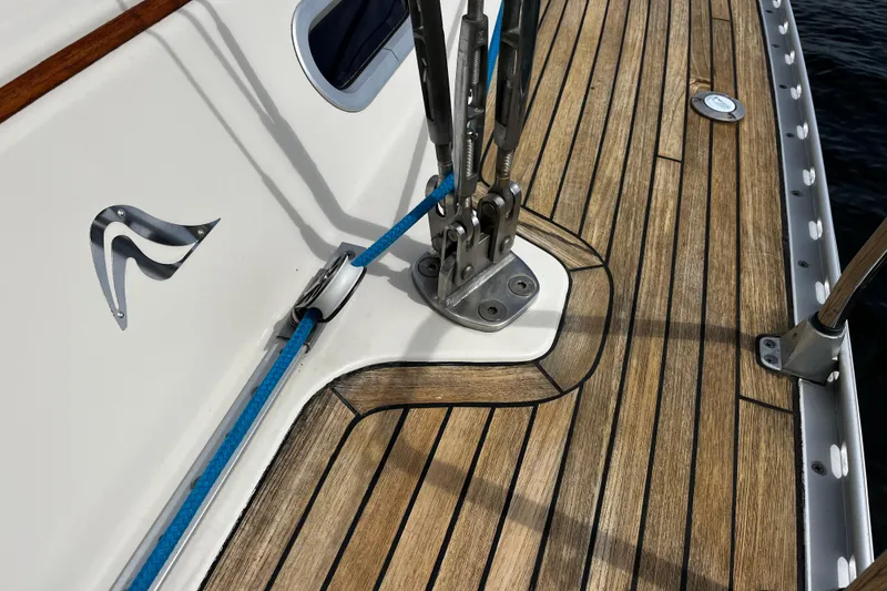 Slide: The Image of Teak deck of 2004 Hanse 411 sailboat with blue rope and metal fittings. - 21
