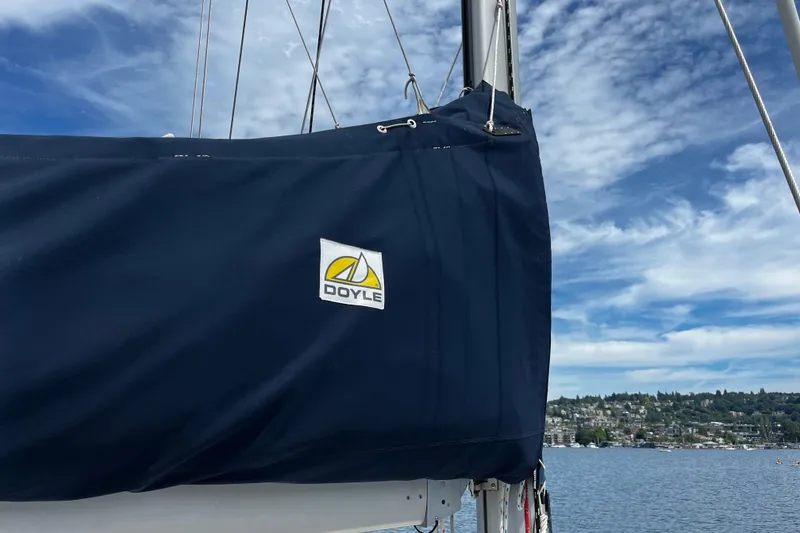 Slide: The Image of Sailboat with Doyle sail cover on a Hanse 411, 2004 model, under a blue sky. - 23
