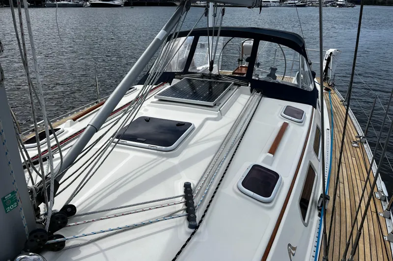Slide: The Image of 2004 Hanse 411 sailboat deck with rigging, docked by the water. - 24