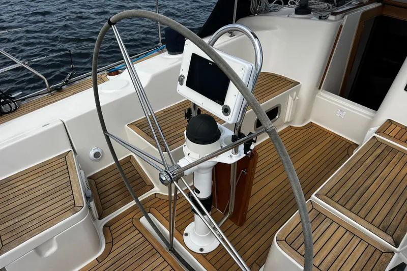 Slide: The Image of Cockpit of 2004 Hanse 411 sailboat with wooden deck and steering wheel. - 28