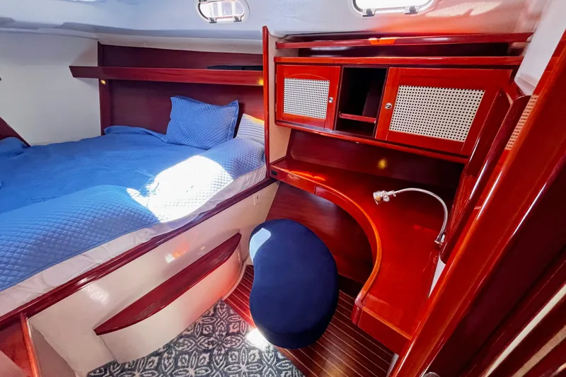 Slide: The Image of Luxurious cabin interior of a 2004 Hanse 411 yacht with wooden furnishings and blue bedding. - 3