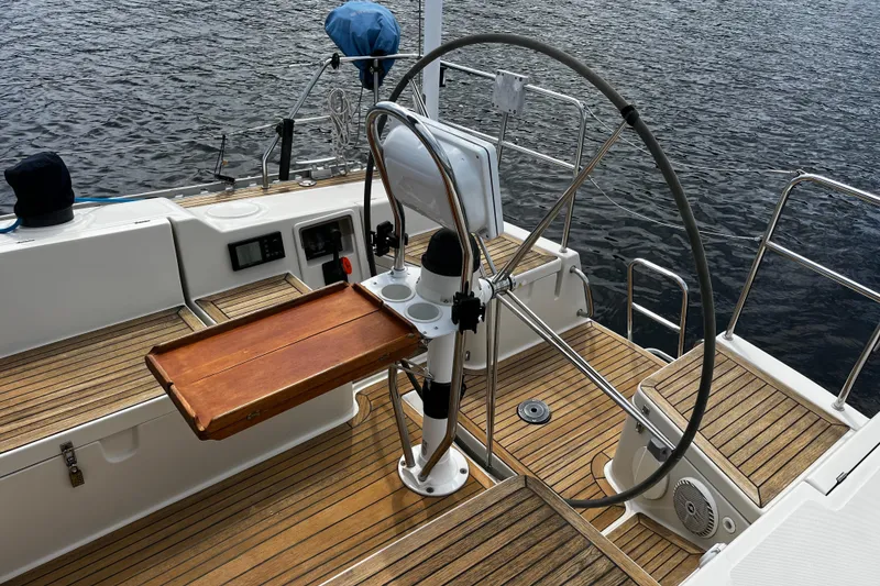 Slide: The Image of Cockpit of 2004 Hanse 411 sailboat with wooden deck and steering wheel. - 31