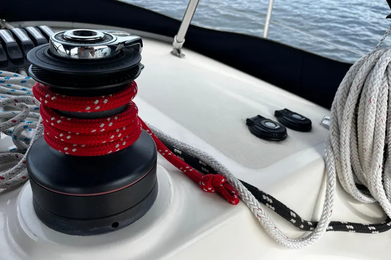 Slide: The Image of Winch and ropes on 2004 Hanse 411 sailboat deck, near water. - 33