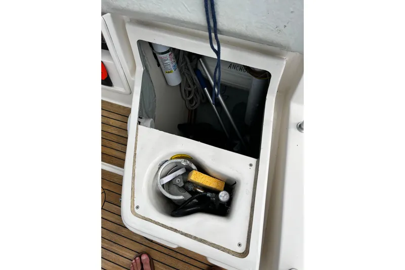 Slide: The Image of Open storage compartment on 2004 Hanse 411 sailboat deck with nautical equipment. - 35