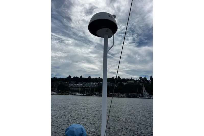 Slide: The Image of Antenna on 2004 Hanse 411 sailboat against cloudy sky and waterfront view. - 38