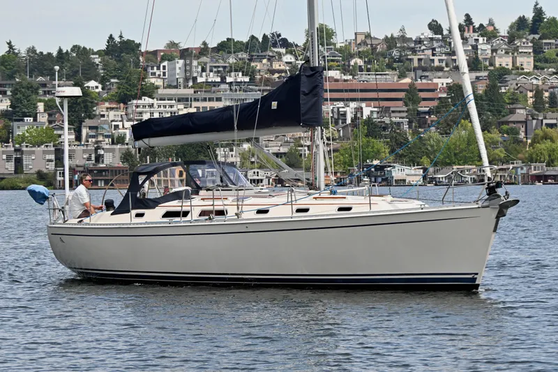 Slide: The Image of Sailing yacht Hanse 411 from 2004 on a calm lake with a scenic urban backdrop. - 41