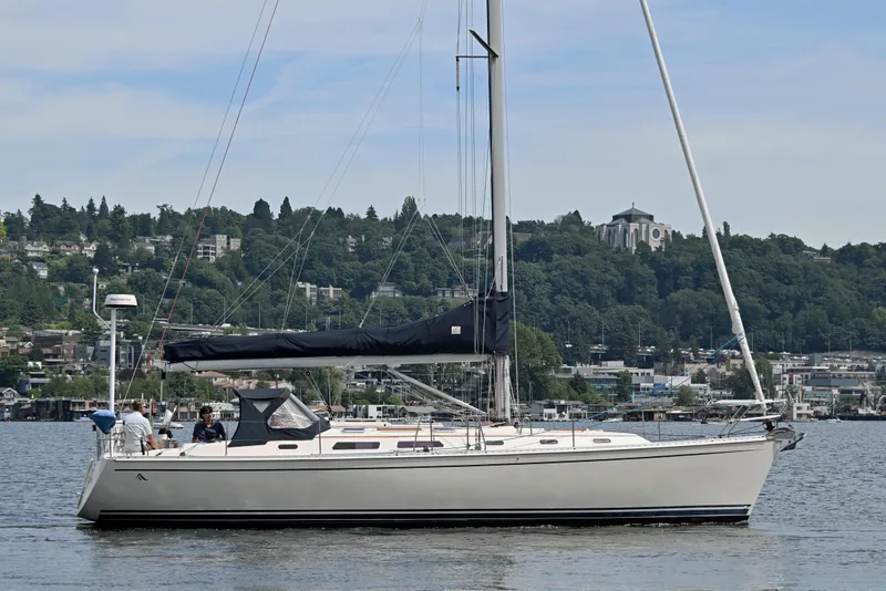 Slide: The Image of 2004 Hanse 411 sailboat on a calm lake with a scenic hillside backdrop. - 42
