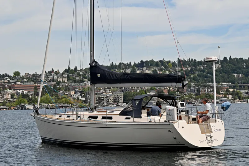 Slide: The Image of 2004 Hanse 411 sailboat cruising on a scenic lake with cityscape background. - 43