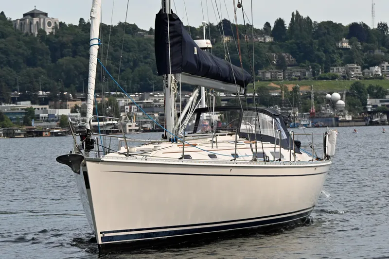 Slide: The Image of 2004 Hanse 411 sailboat cruising on a calm lake with a scenic backdrop. - 44